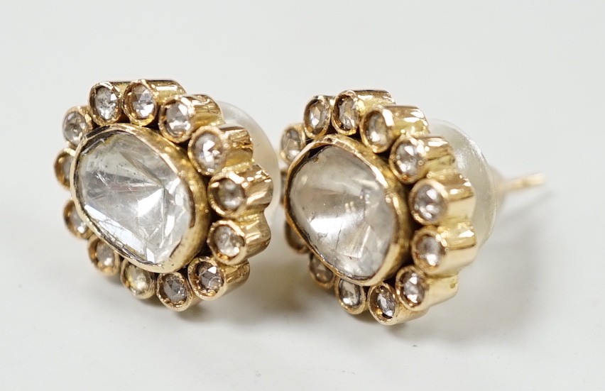 A pair of Indian yellow metal, flat and rose cut diamond set oval cluster earrings, 15mm by 13mm, gross weight 7.8 grams.